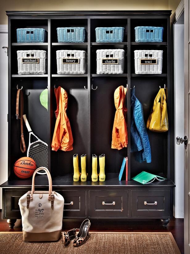 Organized mudroom entryway with cubbies, baskets, backpacks, and shoes neatly arranged